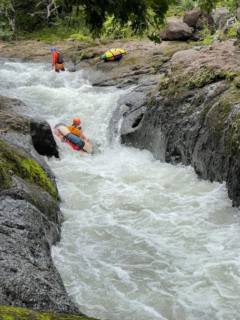 Guest floating on an inner tube through river rapids in Guanacaste