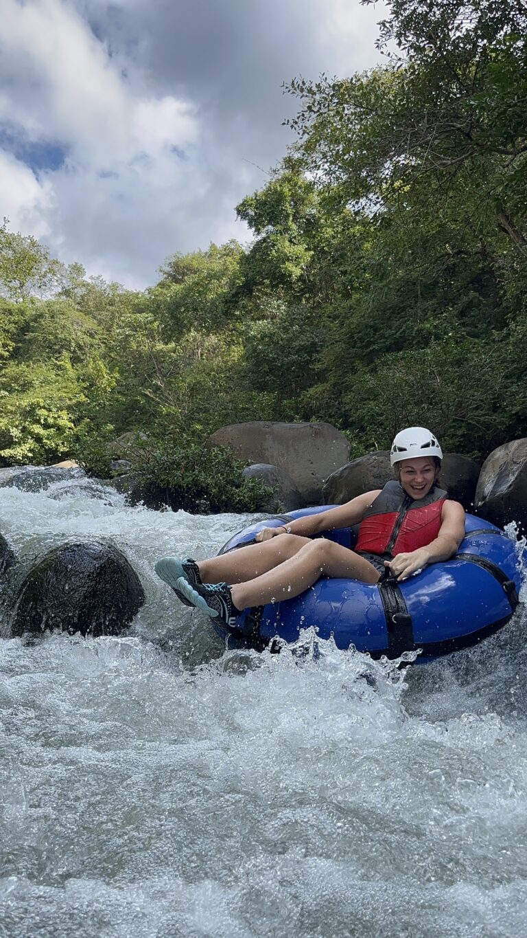 Guide helping a young guest on a Guanacaste river tubing tour