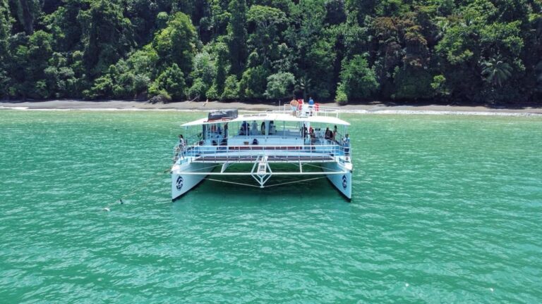 Happy guests waving from the bow on a Guanacaste sailing tour