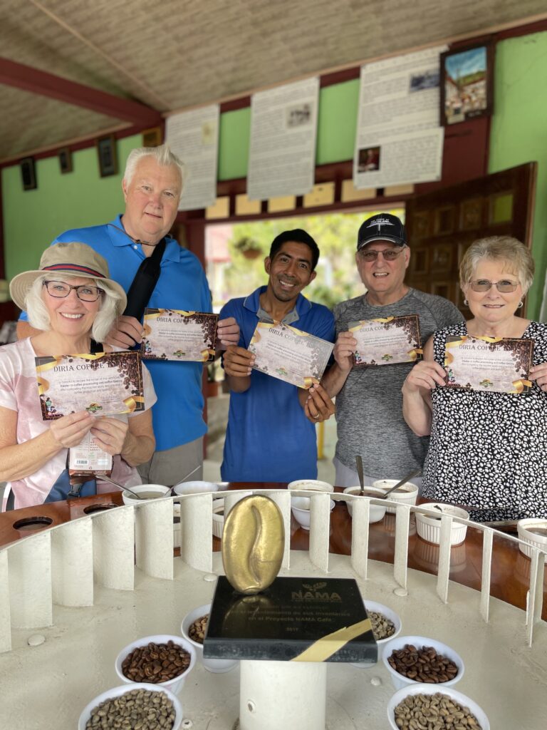 Guide showing an open cacao pod to guests on a chocolate tour