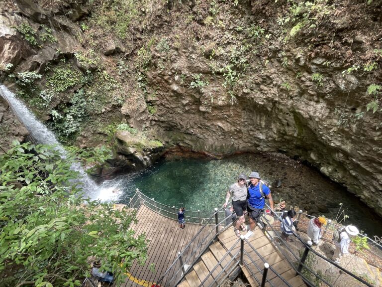 Family visiting Río Celeste waterfall on a private tour from Guanacaste