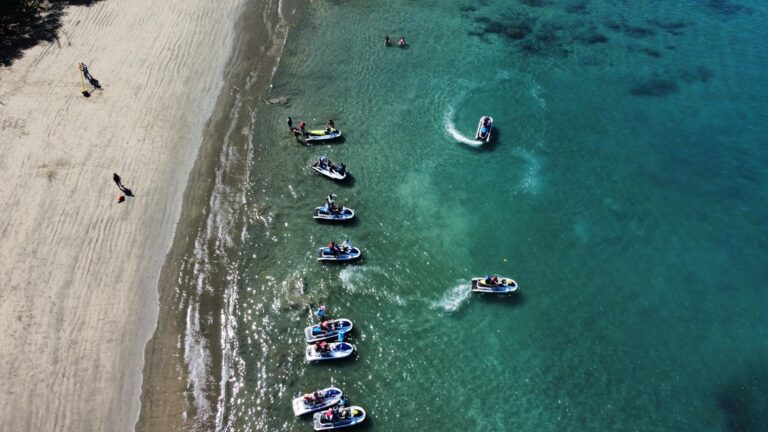 Jet skis lined up on a Guanacaste beach facing the Pacific