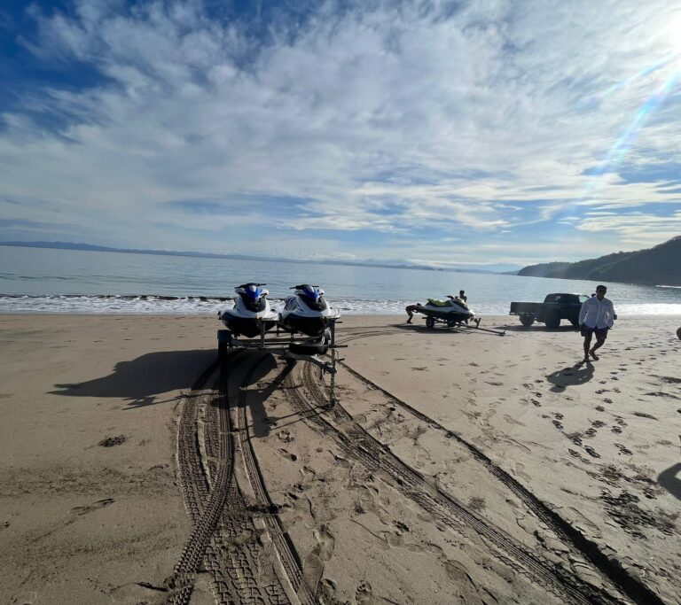 Guests getting on jet skis near the shore in Guanacaste