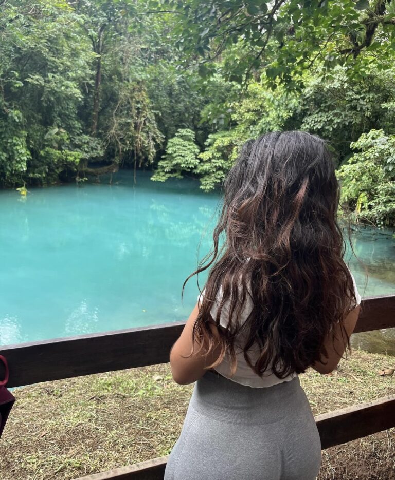 Traveler admiring the turquoise water of Río Celeste, Costa Rica