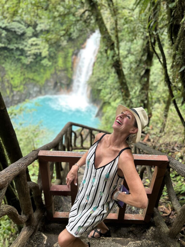 Waterfall falling into a turquoise pool inside a rock canyon, Guanacaste